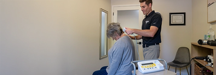 Chiropractor Walnut Creek CA Brandon Holmes Using Device On Patients Neck